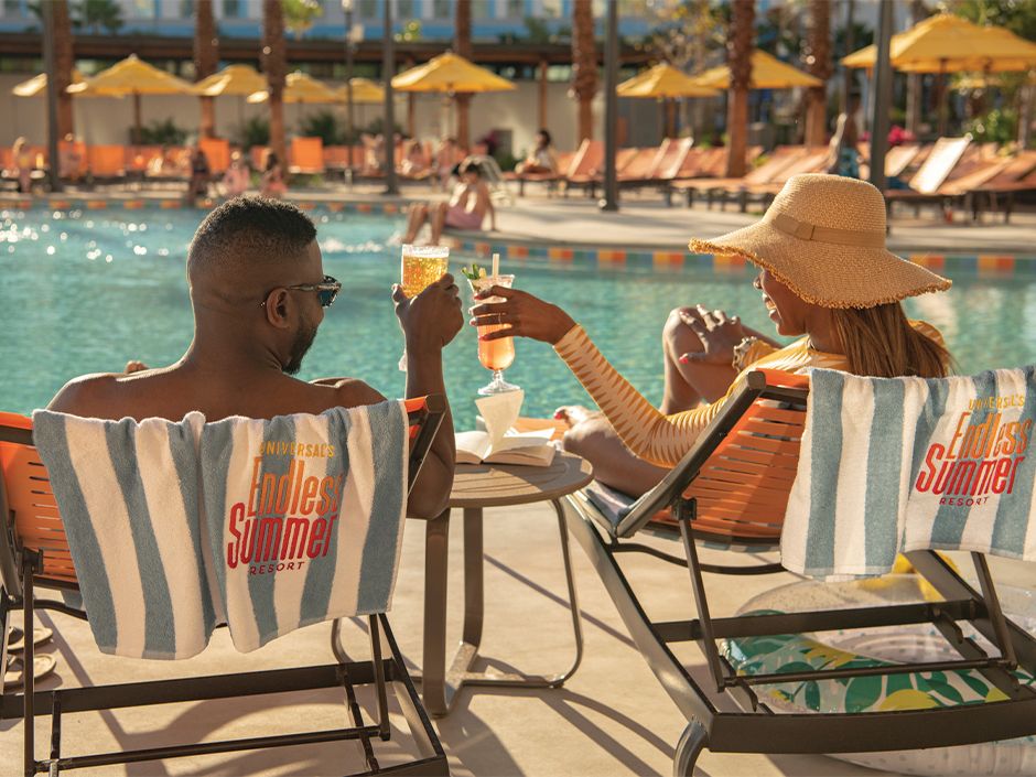 A couple sits by the pool at Universal Endless Summer Resort