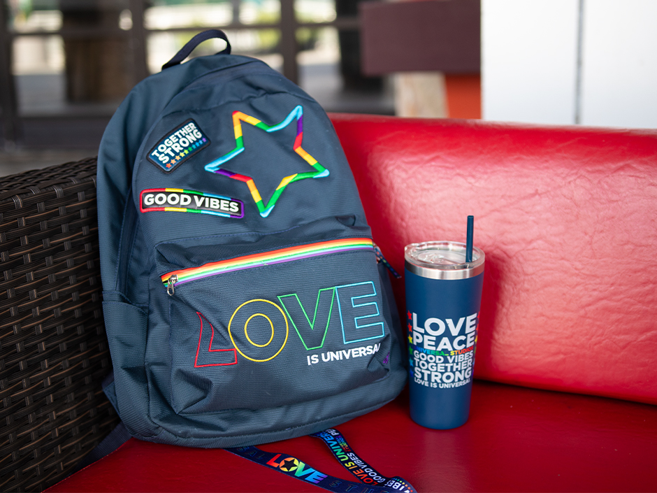 A Love Is Universal backpack, tumbler, and lanyard