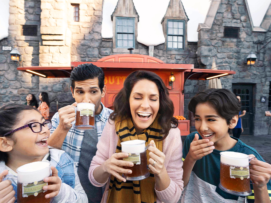 A family enjoys Butterbeer at The Wizarding World of Harry Potter at Univesal Studios Hollywood.