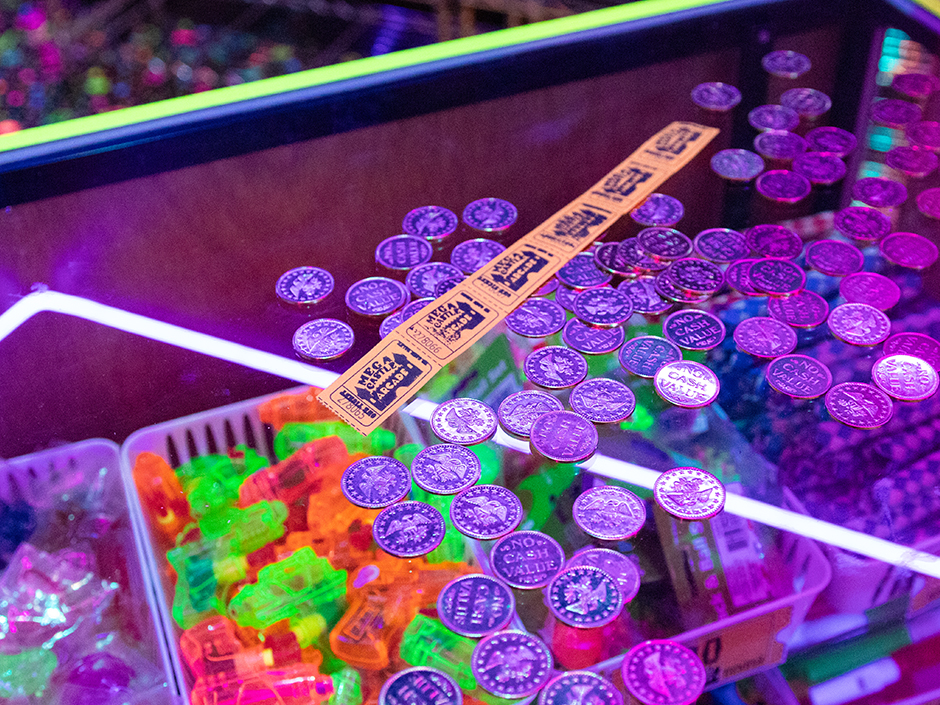 Tokens and tickets on a counter in Mega Castle Arcade