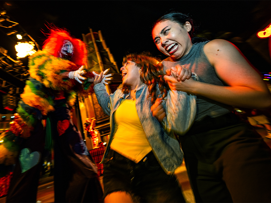 Guests are frightened in a scare zone at Halloween Horror Nights.