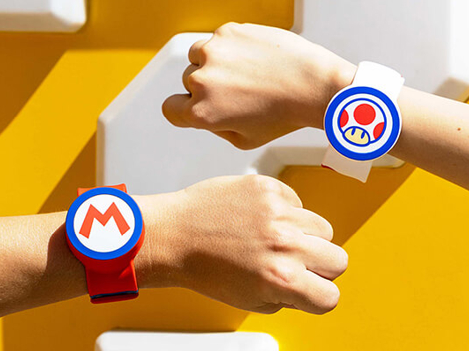 Two guests display their Mario and Toad Power-Up Bands at SUPER NINTENDO WORLD.