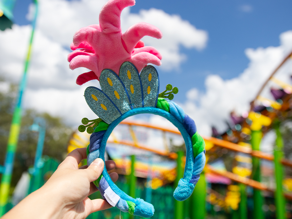 A Poppy headband in front of Trolls Trollercoaster