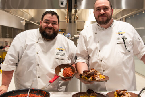 Chef Chris Colon and Chef Marcos Colon smile and hold their favorite family recipes