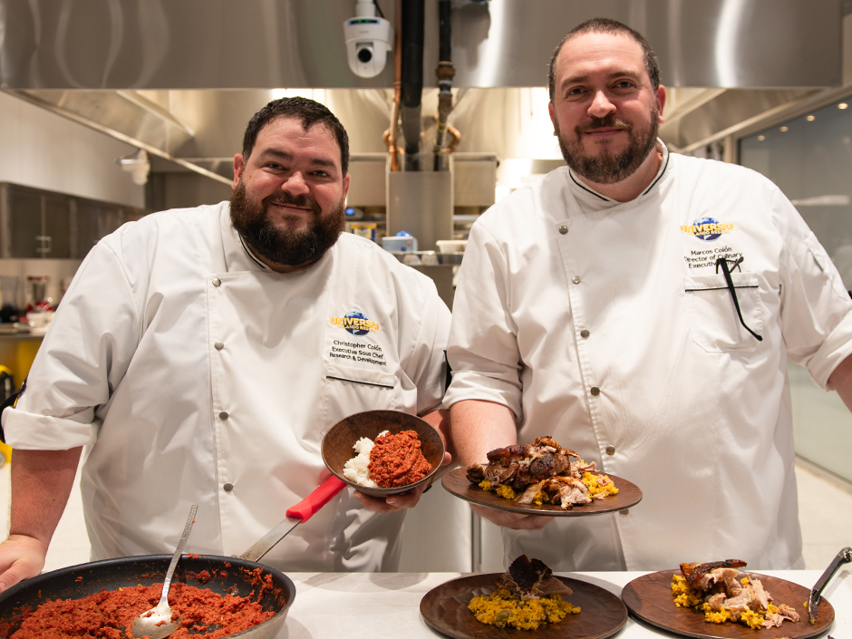 Chef Chris Colon and Chef Marcos Colon smile and hold their favorite family recipes