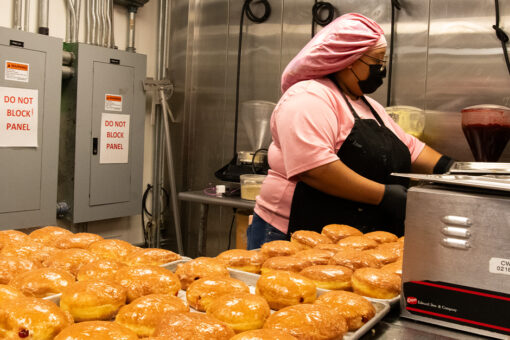 A team member fills doughnuts at Voodoo Doughnut in Universal CityWalk