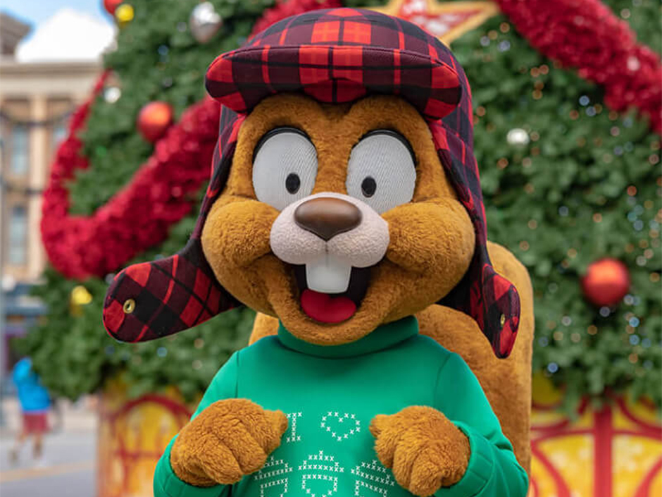 Earl the Squirrel poses in front of a Christmas tree