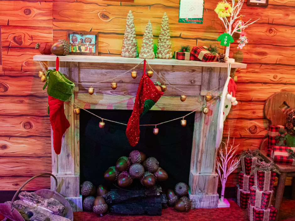 Earl the Squirrel's fireplace decorated in Christmas decor at Green & Red Coconut Club.