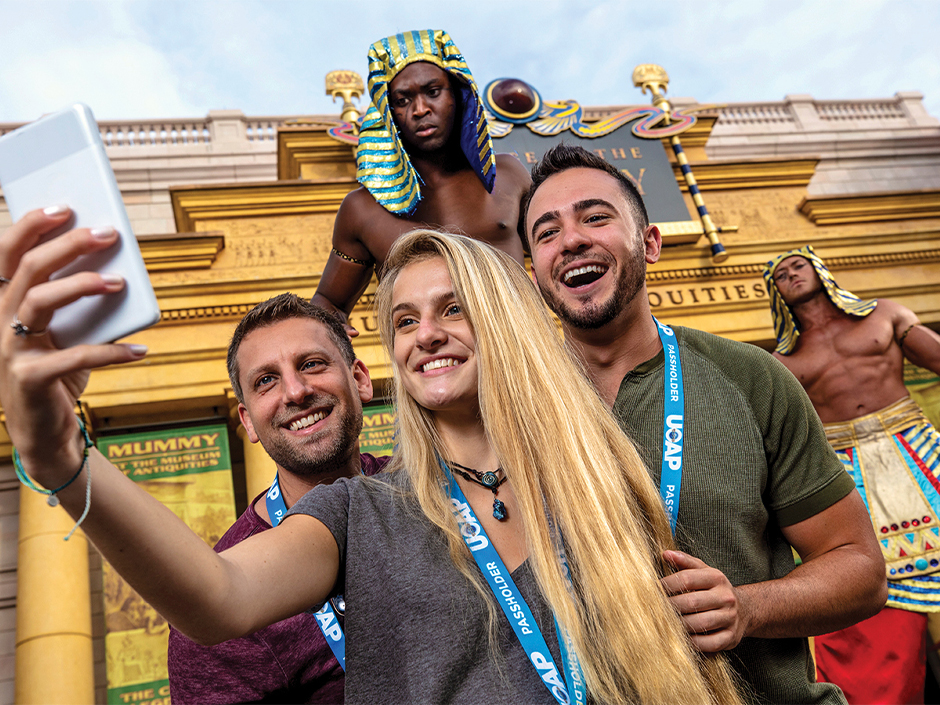 Passholders taking a selfie in front of Revenge of the Mummy at Universal Studios Florida