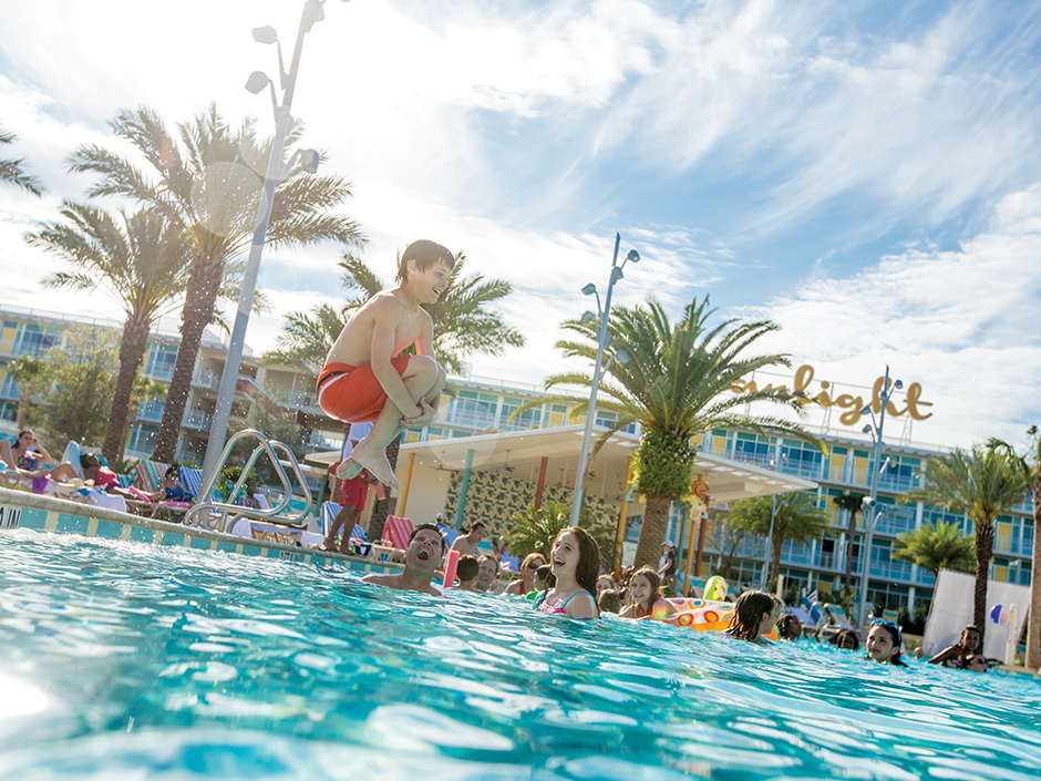 A boy is jumping into the pool at Cabana Bay Beach Resort