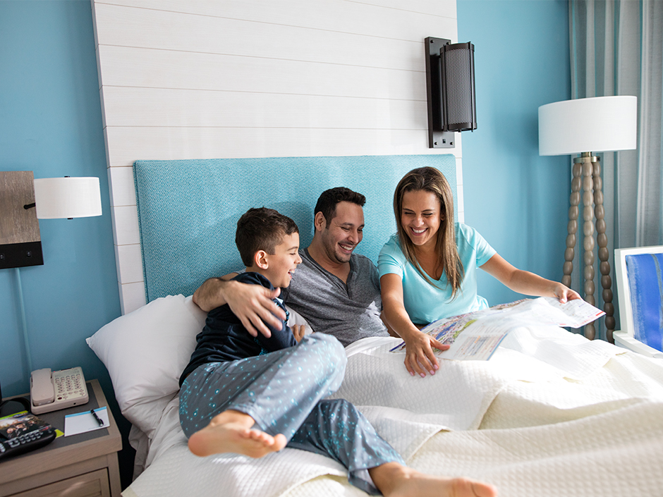 A family looking at a Universal theme park map in their hotel room