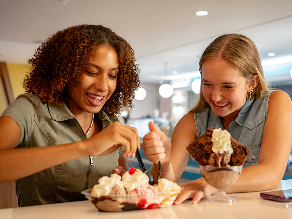 Two young women enjoying some ice cream at Cabana Bay Beach Resort