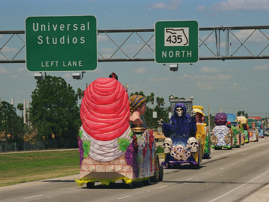 An archival photo of Universal Mardi Gras parade floats driving down I-4