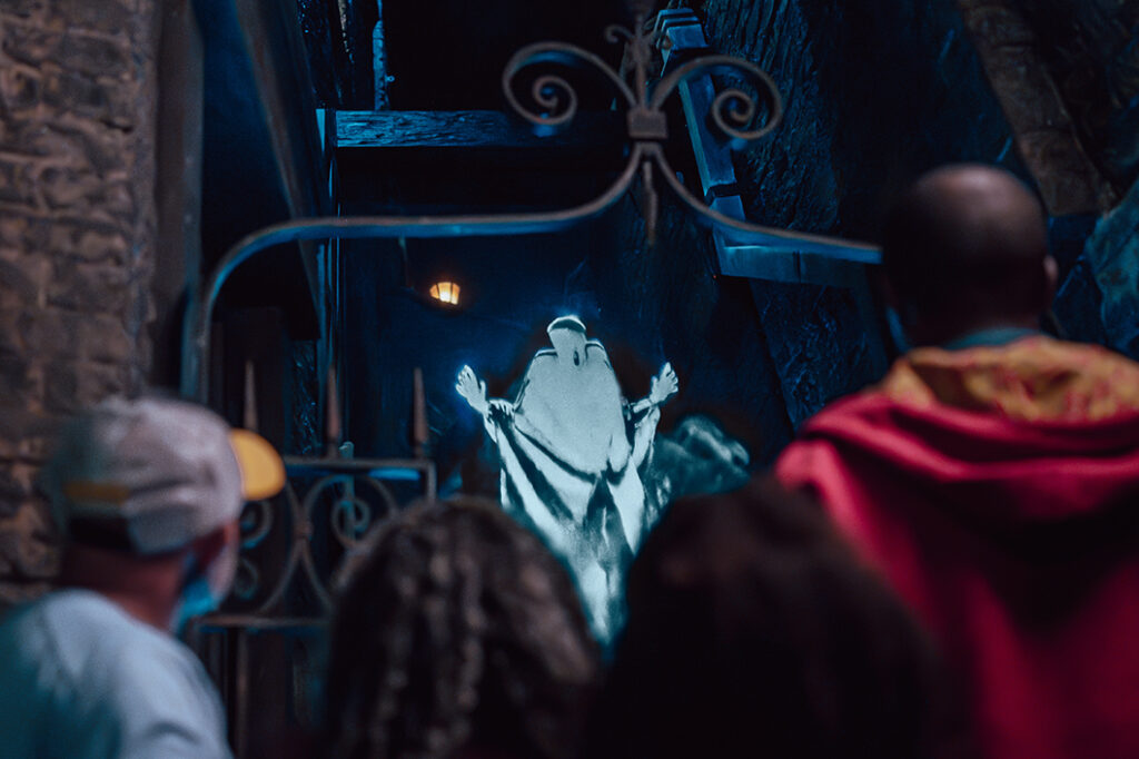 A family casts a spell at a dementor with a 2nd Generation Interactive Wand in The Wizarding World of Harry Potter - Diagon Alley