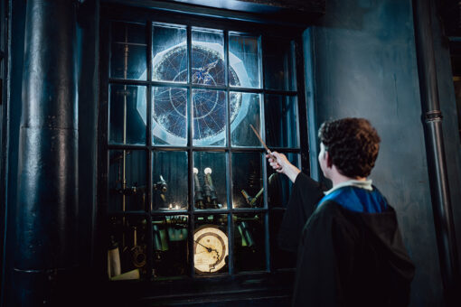 A guest casting a spell with a 2nd Generation Interactive Wand in The Wizarding World of Harry Potter - Diagon Alley