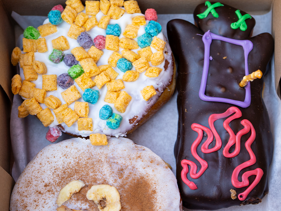 A box of colorful Voodoo Doughnuts. 