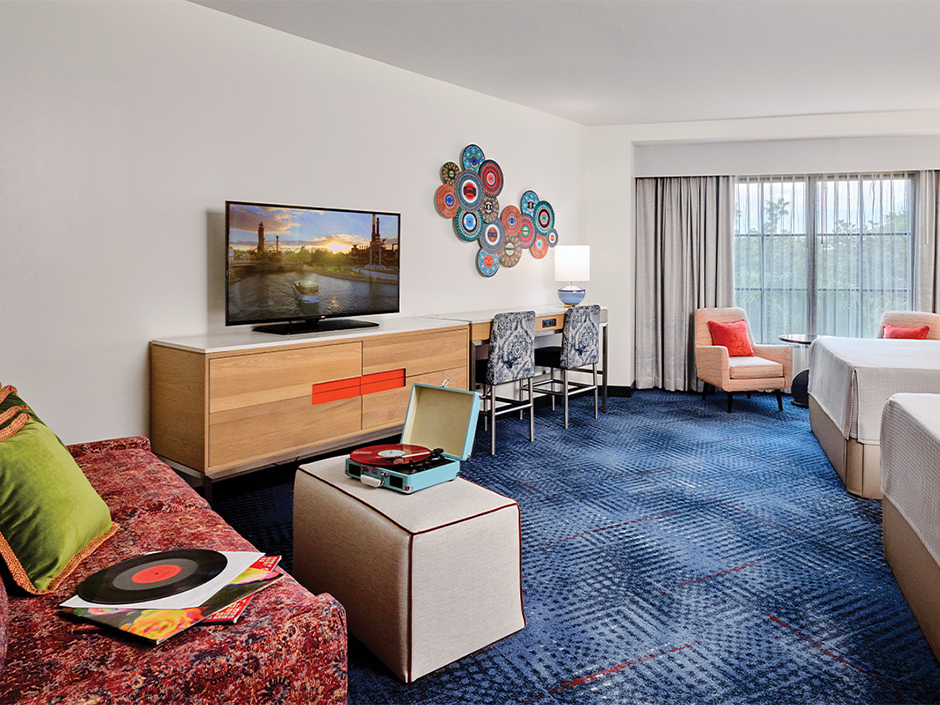 A view of a room in the Hard Rock Hotel, with a Crosley turntable on a table in front of the sofa