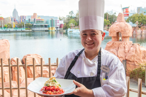 Mythos Assistant Chef Britney Drescher posing with her dessert for Women's Herstory Month.