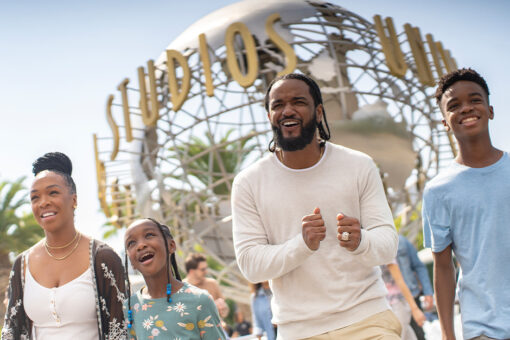 A family of guests with the globe outside Universal Studios Hollywood.