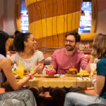 A group of guests dine at Toadstool Cafe at SUPER NINTENDO WORLD.