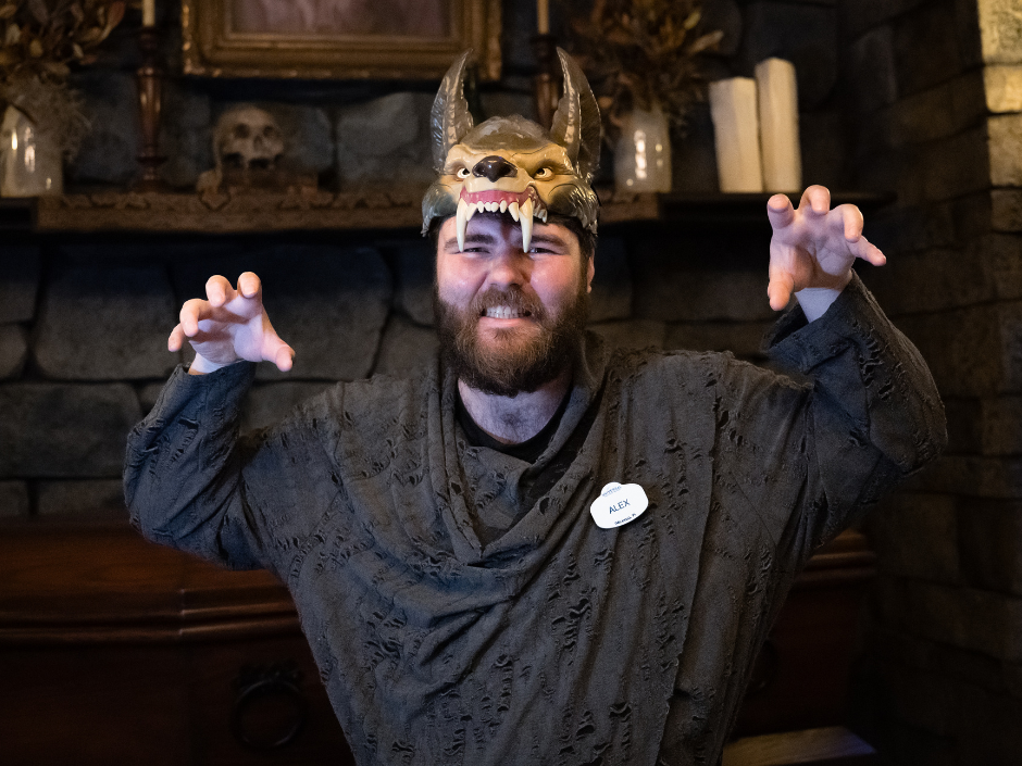 A Darkmoor Monster Makeup Experience team member wears a werewolf hat and "growls" at the camera