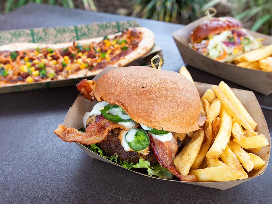 The Kohola Burger, Huli Huli Chicken Sandwich, and Vegan Longboard Pizza from Volcano Bay 