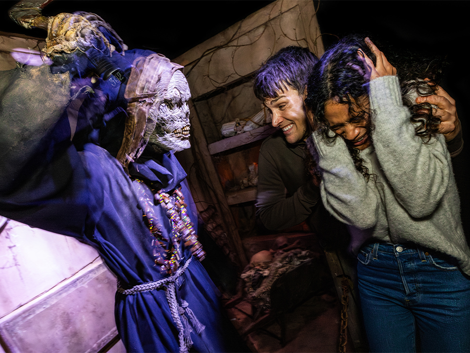 Guests are frightened by a monster at Halloween Horror Nights 2024.