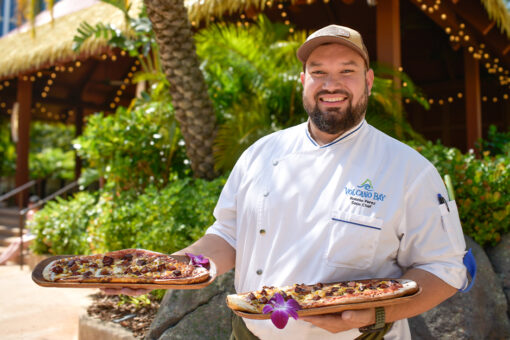 Chef Ronnie holding up flatbreads in Volcano Bay