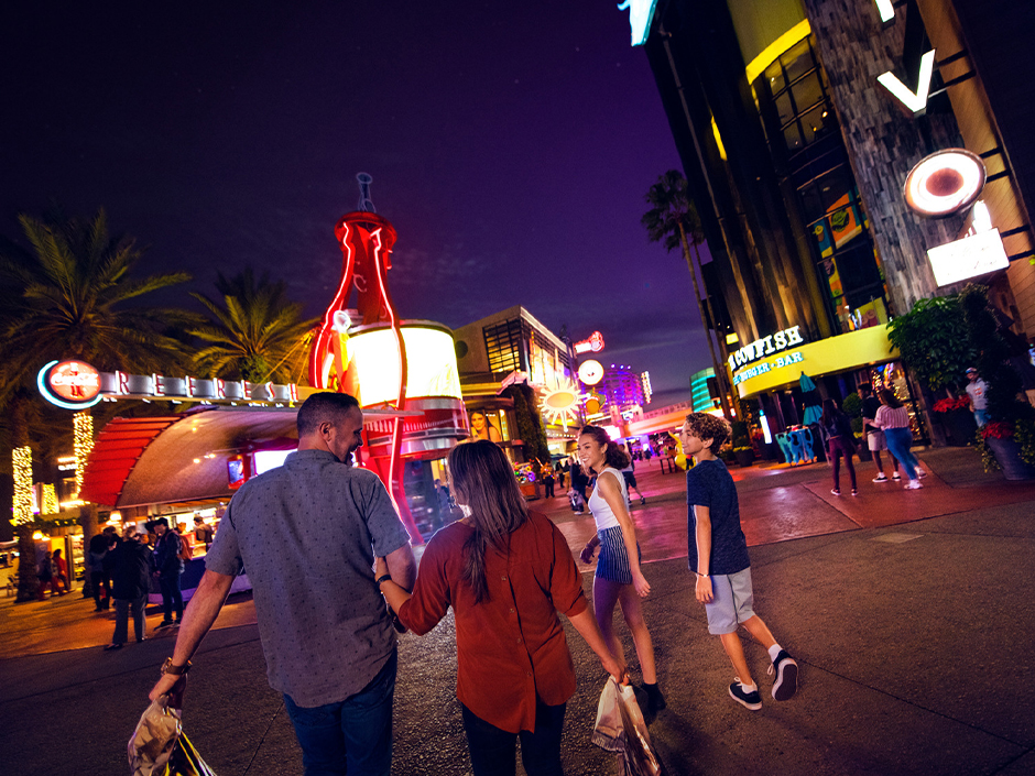 A group of friends walking through Universal CityWalk at night