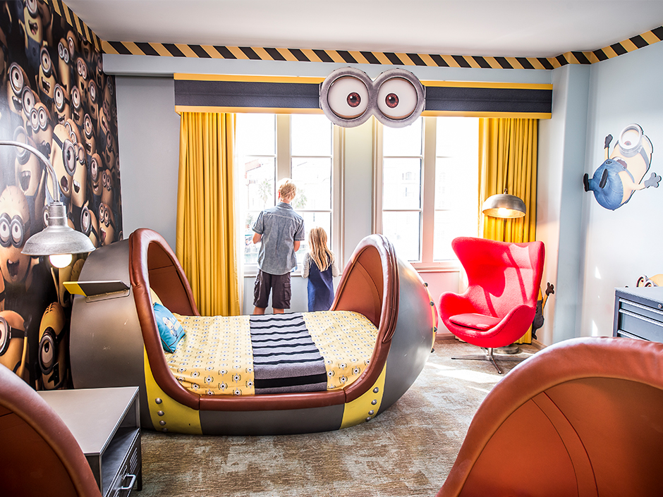 Two children look out window from Minion-themed suite at Portofino Bay Hotel