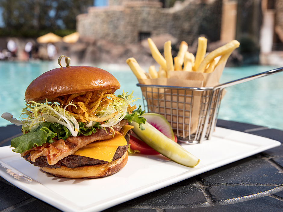 A burger and fries poolside