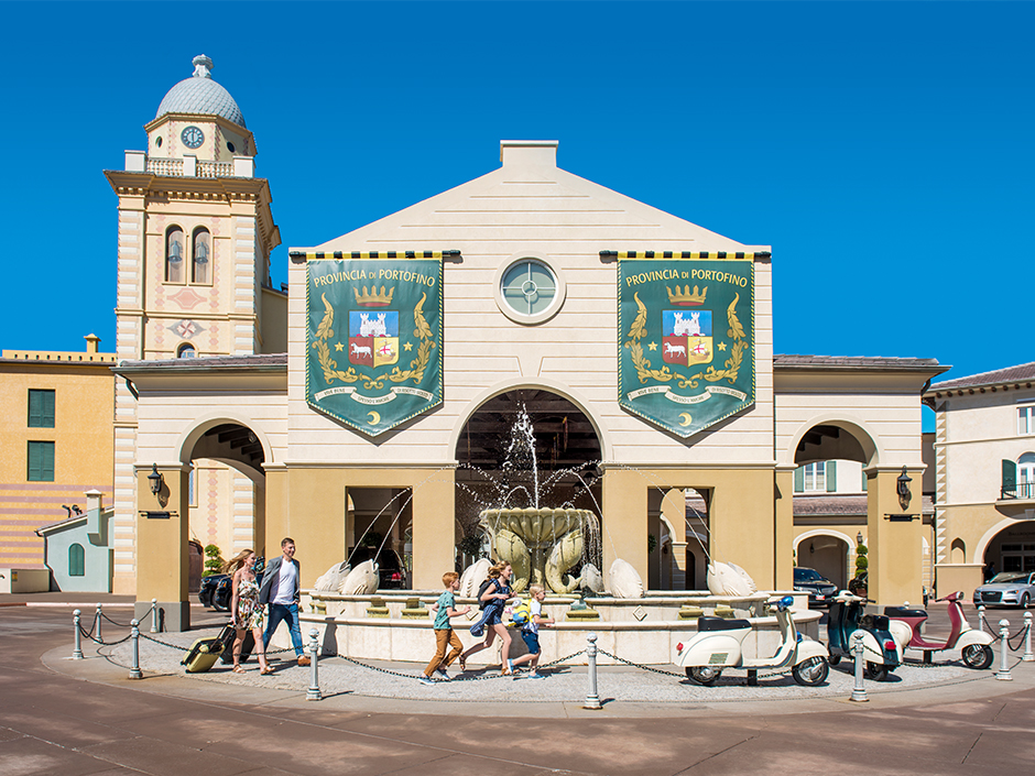 People walking outside of entrance of Portofino Bay Hotel