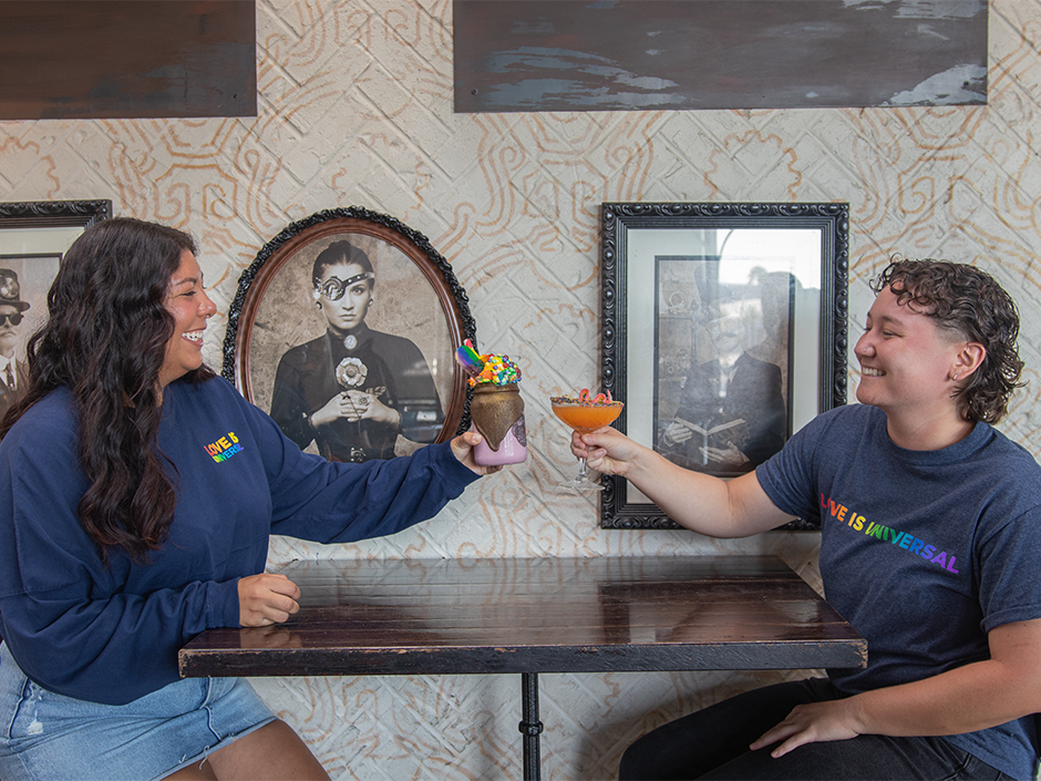 Two women toast their milkshake and drink at The Toothsome Chocolate Emporium in CityWalk