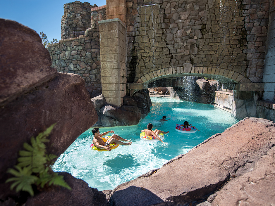 Pool view of people floating in tubes