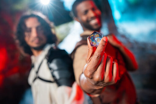 Fans cosplaying Dungeons & Dragons characters, holding up a die.