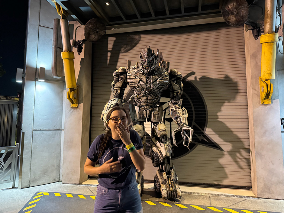 A guest smiles with Megatron at UOAP Nights