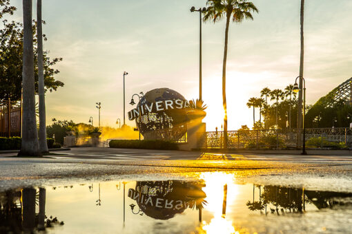 The Universal Studios Florida globe reflected in a puddle at sunset