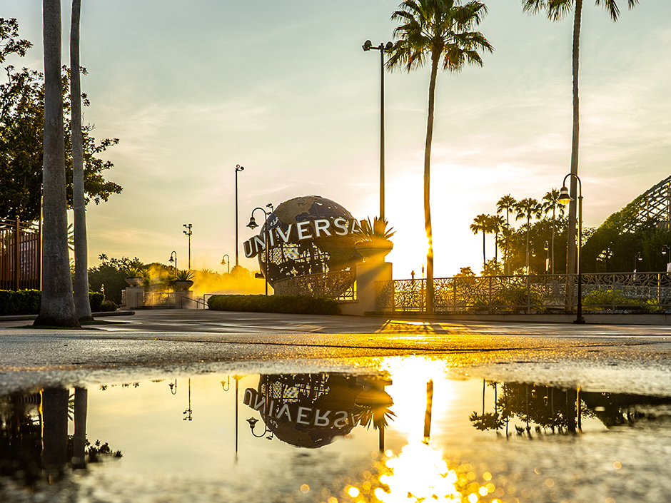 The Universal Studios Florida globe reflected in a puddle at sunset