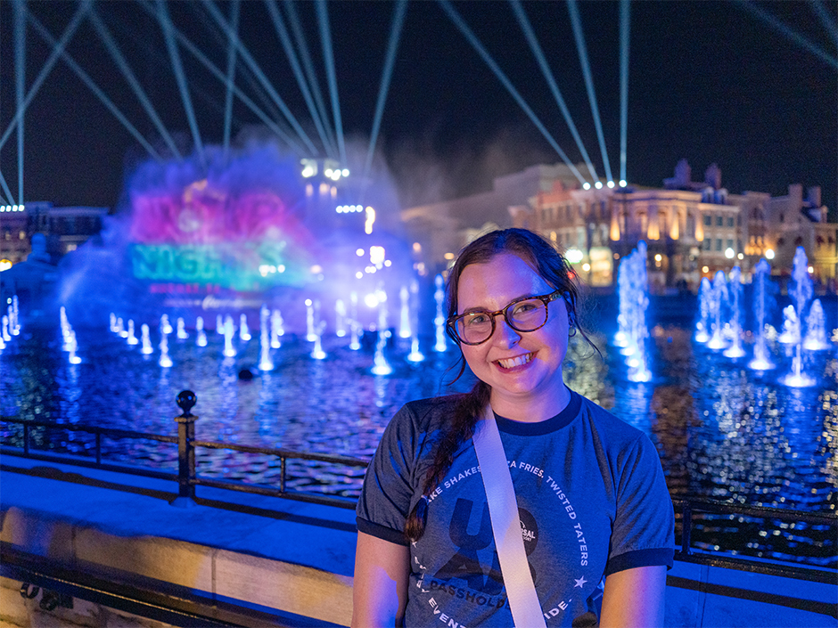 A guest poses in front of CineSational during UOAP Nights