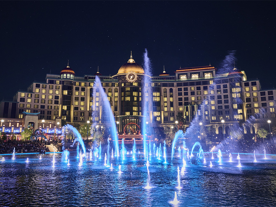 The fountains in front of Helios Grand Hotel at night