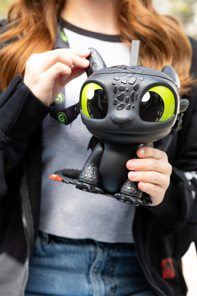 A guest holds a Toothless Sipper
