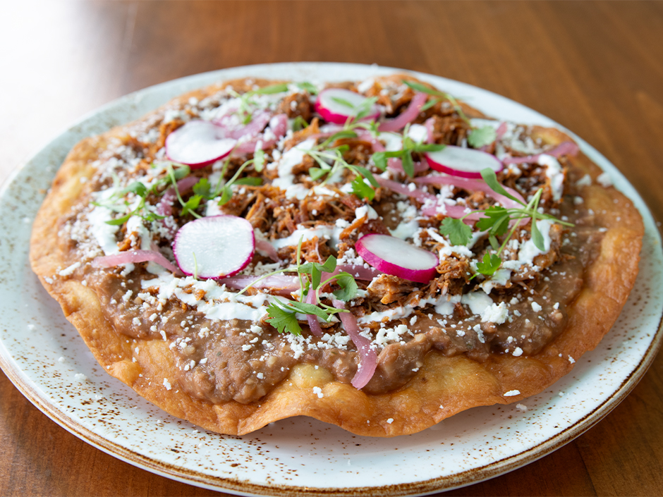 Tlayuda on a plate in Antojitos Authentic Mexican Food in Universal CityWalk