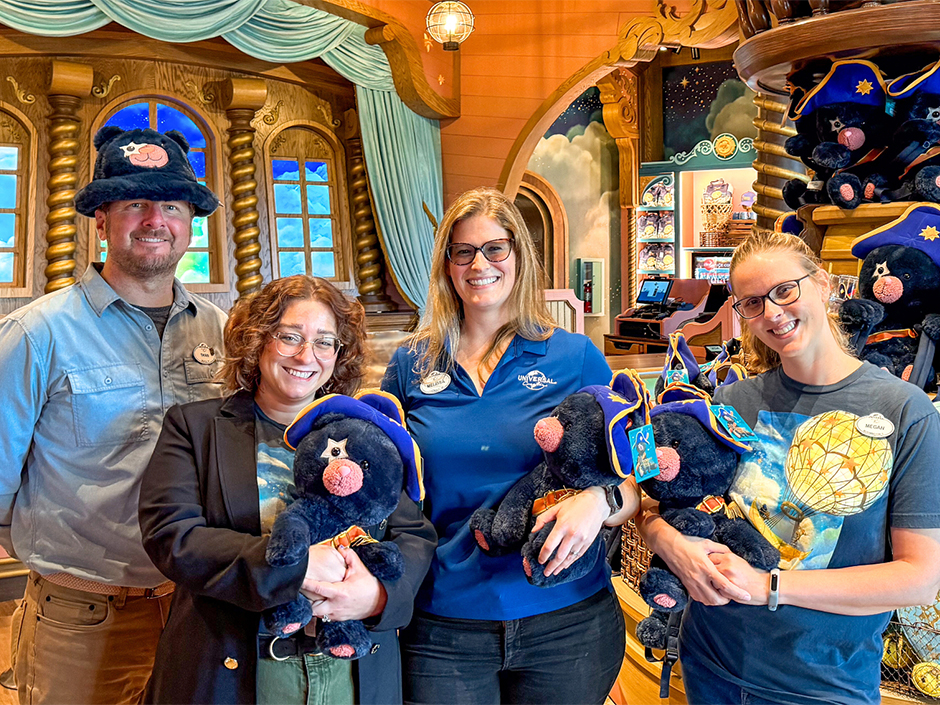 The Universal Creative Design Team holding Captain Cacao plushes