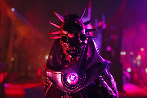 A scare actor in the Dark Zodiac scare zone from Halloween Horror Nights 2024
