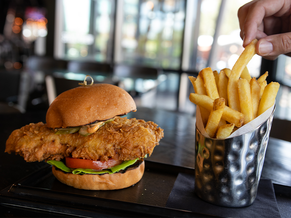 The Cowboy Candy Chicken Sandwich with a side of fries in NBC Sports Grill & Brew in Universal CityWalk