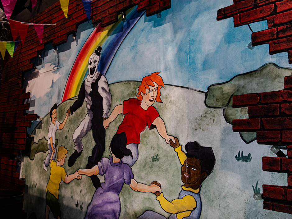 A painting of Art the Clown dancing with children in the Terrifier haunted house