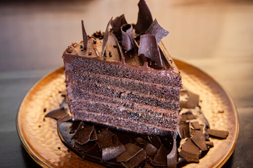 A 7 Layer Chocolate Decadence Cake on a plate at The Toothsome Chocolate Emporium & Savory Feast Kitchen at Universal CityWalk.