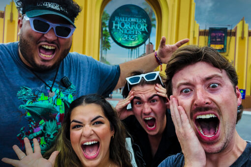 Members of the Fanny Pack point at the Universal Studios Florida entrance and pretend to scream