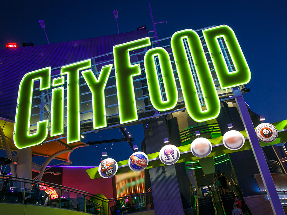 Neon green sign reading "CITYFOOD" on CityWalk.