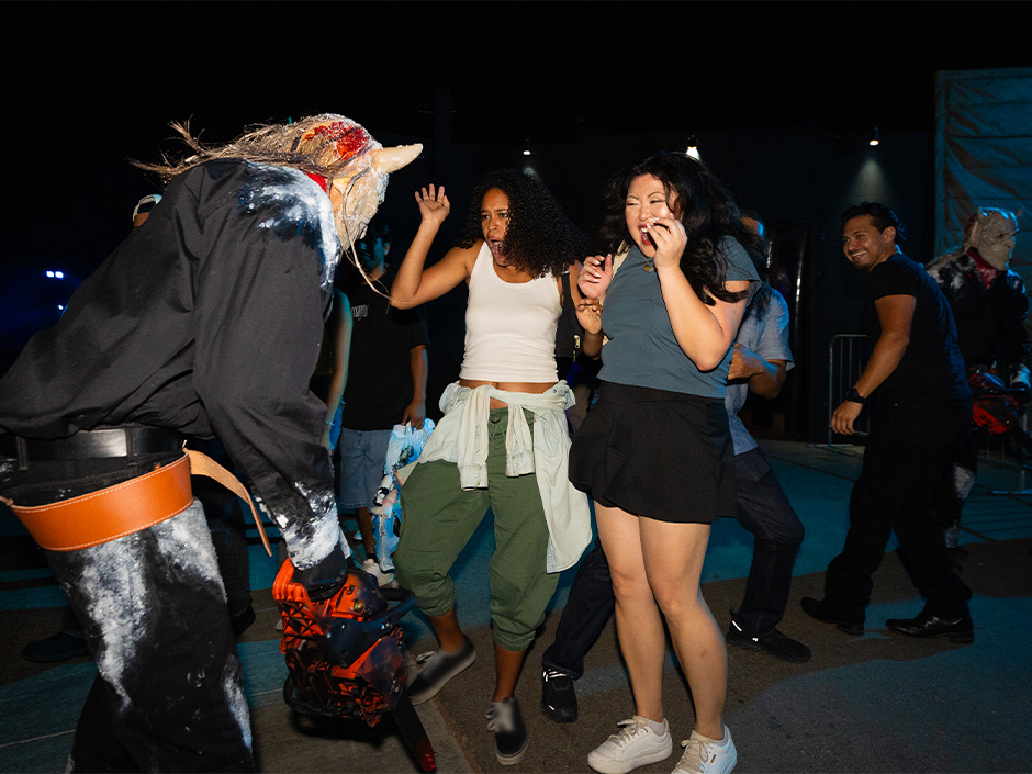 Guests are scared by a creature on the Terror Tram at Halloween Horror Nights.